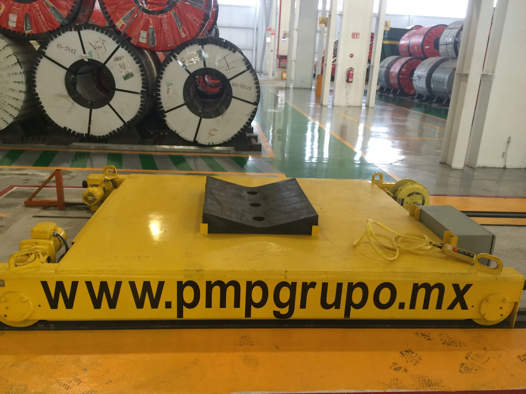 Yellow transfer car for handling steel coils inside an industrial facility