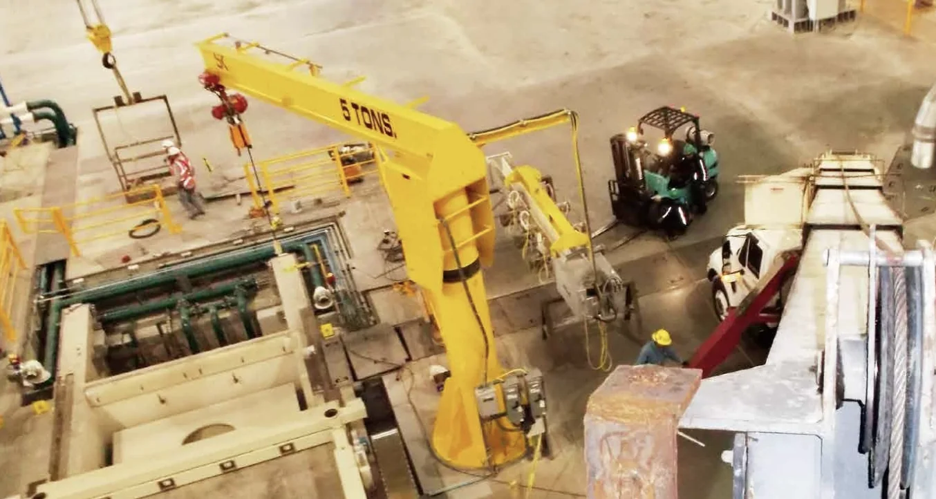 Yellow 5-ton jib crane installed above a production area