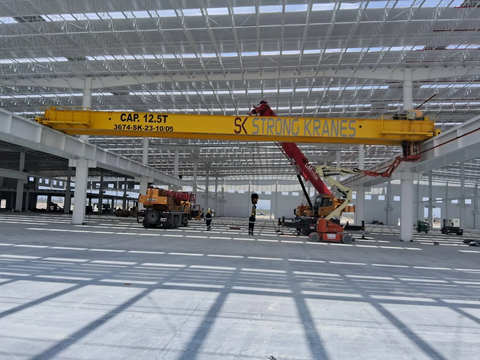 Grúa viajera bipuente amarilla de 12.5 toneladas durante su instalación en una nave industrial